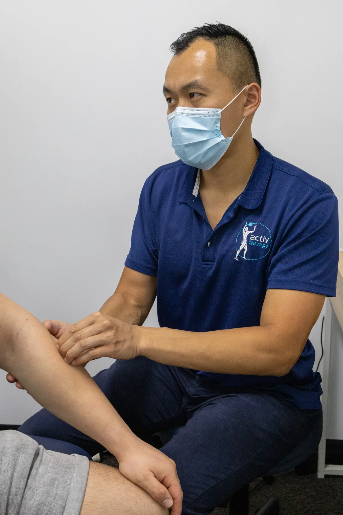 Physiotherapist assessing a patient’s knee joint