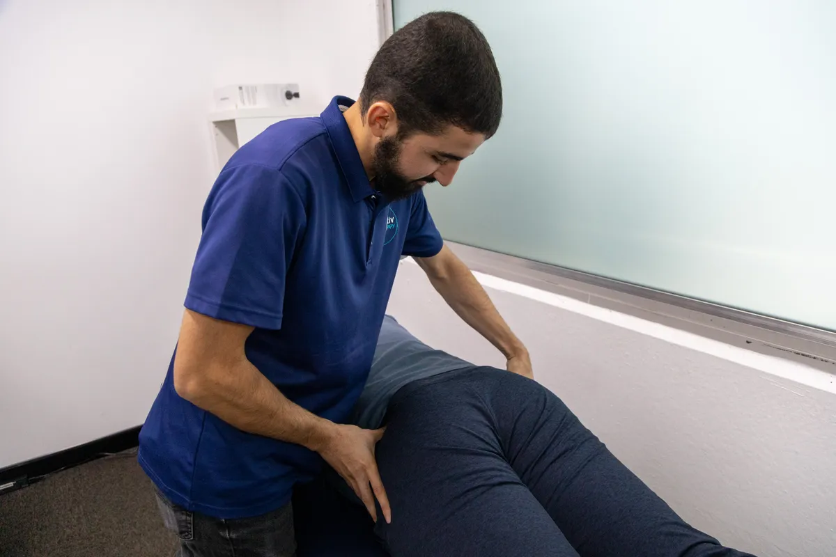 Physiotherapist performing hands-on therapy on a patient’s leg
