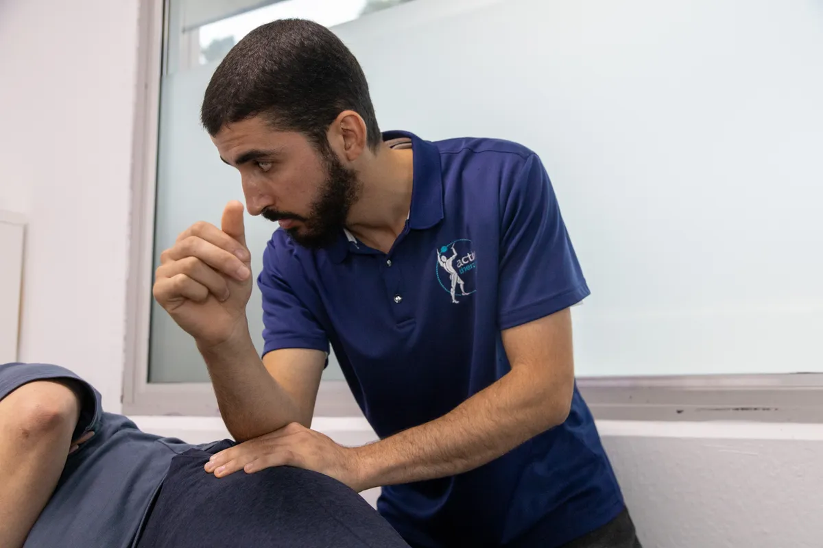 Physiotherapist treating a patient’s knee and surrounding muscles