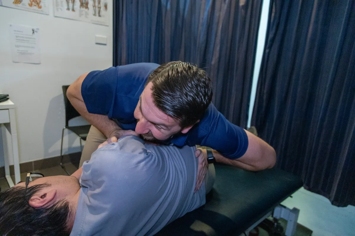 Chiropractor performing a spinal adjustment on a patient’s neck