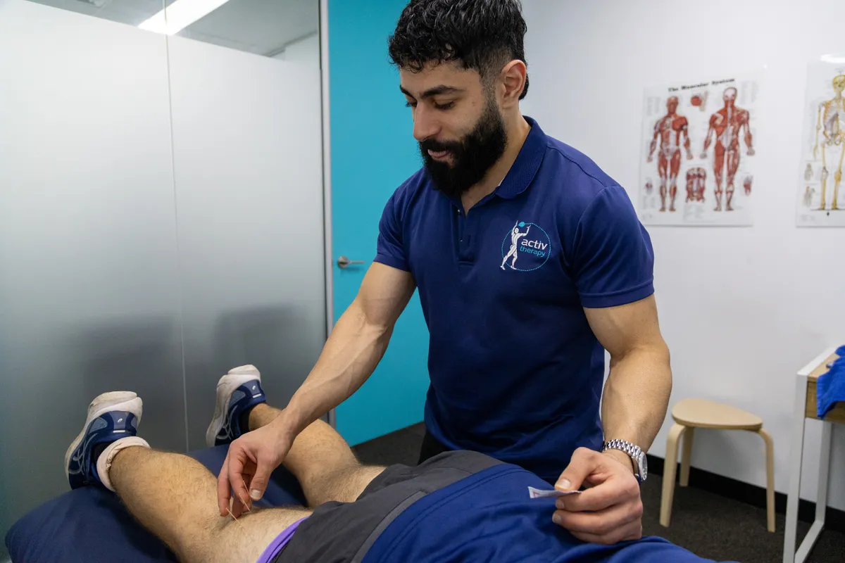 Physiotherapist treating a patient’s calf and lower leg