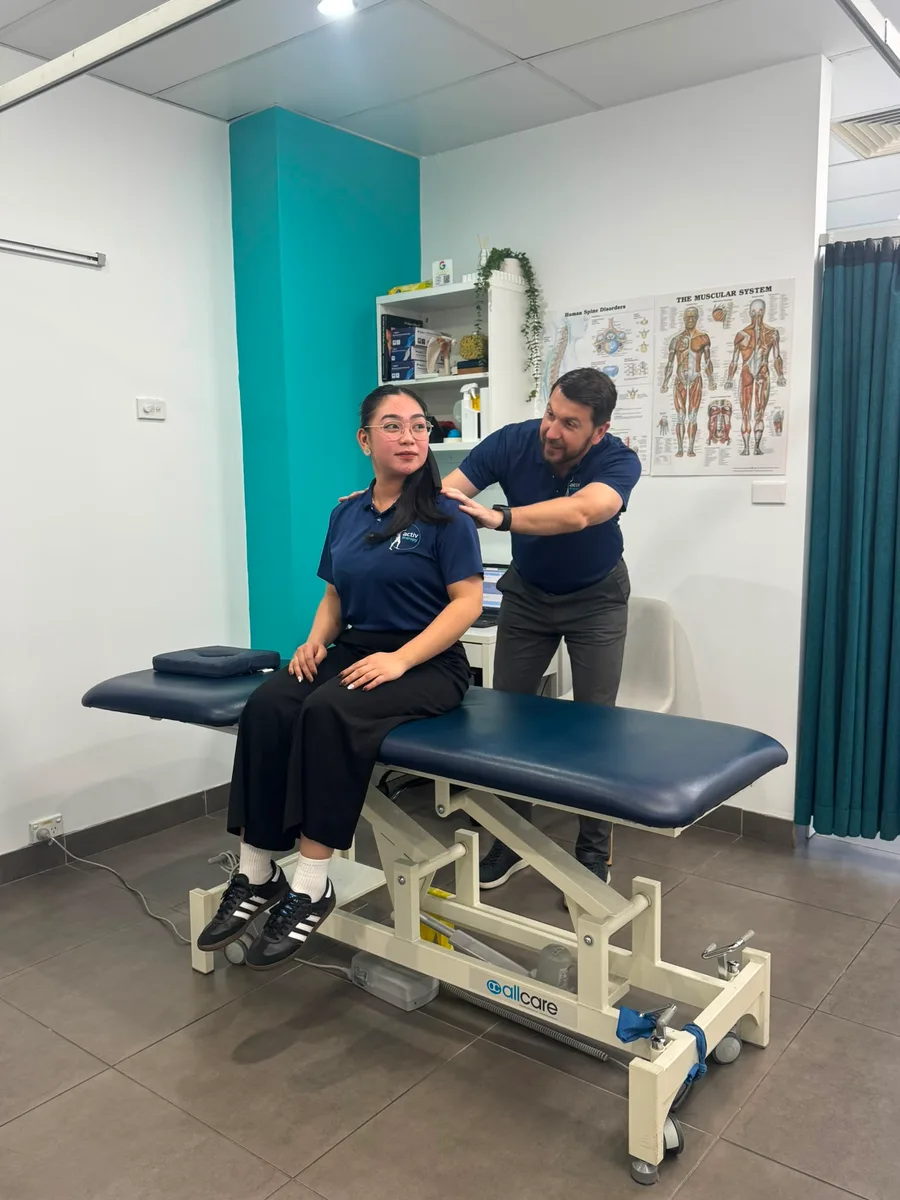 Activ Therapy physiotherapist assessing a patient’s neck and posture during a TMJ appointment